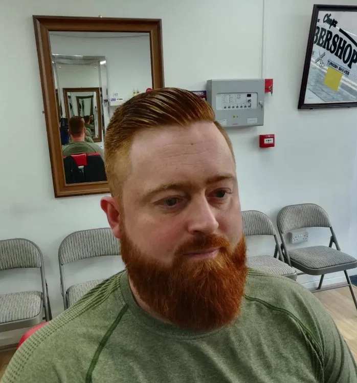 Full beard with slick side part